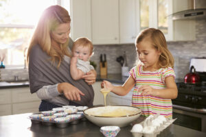 Mom with young daughters in the kitchen