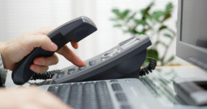 close up of hands dialing a phone