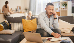 man working from home with his family in the background