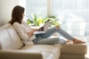woman sitting on the couch with laptop