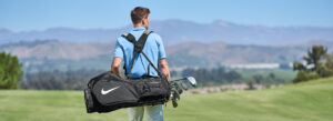 golfer carrying golf bag