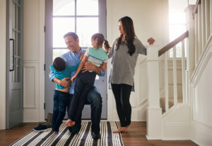 kids and wife greeting dad at the front door.